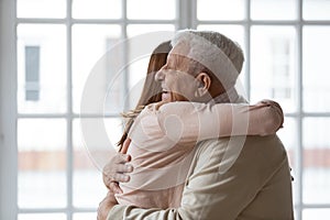 Close up happy older mature man hugging grownup daughter