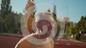 Close up happy pensioner smiling joy jumping rope old man enjoy skip leap recovery motion morning powerful leg sportsman