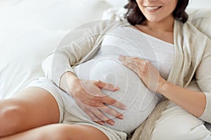 Close up of happy pregnant woman in bed at home