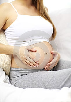 Close up of happy pregnant woman at home