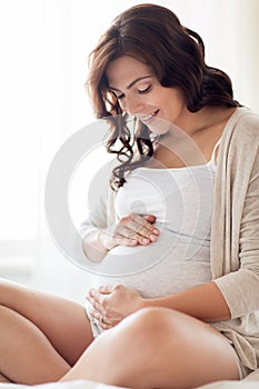 Close up of happy pregnant woman at home