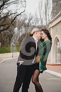 Close up of happy romantic attractive young couple hugging at the street