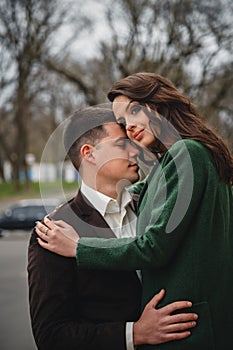 Close up of happy romantic attractive young couple hugging at the street