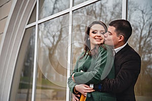 Close up of happy romantic attractive young couple smiling and hugging at the street