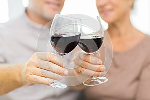 Close up of happy senior couple with red wine