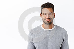 Close-up happy smiling confident macho man with bristle in stylish grey sweater, looking trustworthy and sincere with