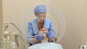 Close-up of happy smiling girl in dentistry at the doctor`s office.