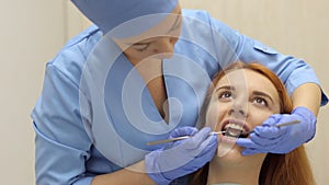 Close-up of happy smiling girl in dentistry at the doctor`s office.