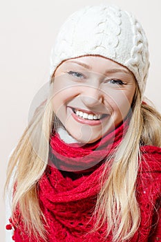 Close up on happy smiling & looking at camera beautiful woman wearing knitted hat and scarf