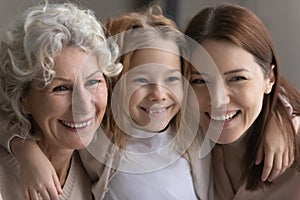 Close up of happy three generations of women hugging