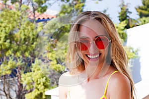 Close Up Happy Woman Face Summer Holidays. Summertime Smile Girl with Blond Hair at summer vacation in swim suit. Selective focus