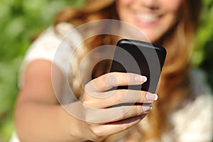 Close up of a happy woman hand using a smart phone