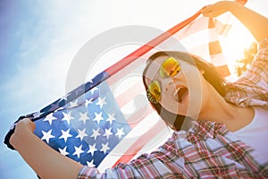 Close up happy woman holding United States of America flag