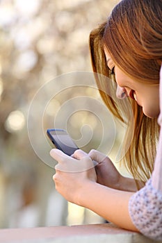 Close up of a happy woman using a smart phone