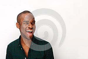 Close up happy young african american guy laughing against isolated white background