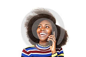 Close up happy young african american woman talking on cellphone against isolated white background