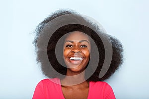 Close up happy young black woman against blue background