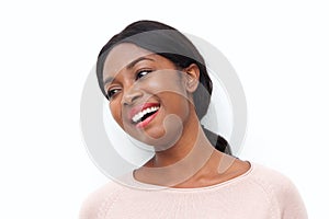 Close up happy young black woman laughing and looking the side against white background