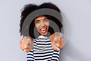 Close up happy young black woman smiling and pointing fingers