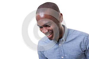 Close up happy young businessman laughing against isolated white background