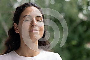 Happy woman breathe fresh air dreaming with eyes closed photo