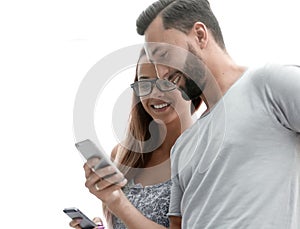 Close up.Happy young couple looking at mobile phone.