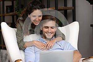 Close up happy young family using laptop together, shopping online
