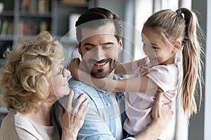 Close up happy young man with daughter and mature mother