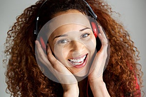 Close up happy young woman listening to music with headphones