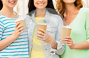 Close up of happy young women drinking coffee