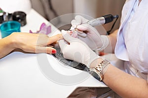 Close-up hardware manicure in salon. Removal of old gel varnish.