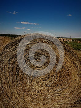 Close up of hay bale, bright  blue sky