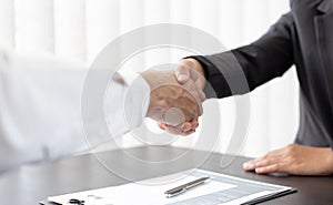 Close-up of Head of Human Resources and new employees Shake hands to congratulate them on their collaboration