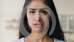 Close up head shot frustrated sad lonely Indian ethnic woman businesswoman looking at camera pensive anxious sight