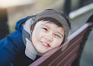 Close up head shot kid looking at camera with smiling face, Healhty child with happy face with blurry background. Yong boy