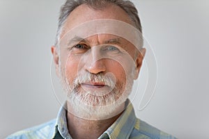 Close up head shot portrait of handsome pleasant mature man.