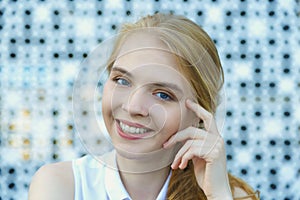 Close up head shot of smiling european blond haired young woman