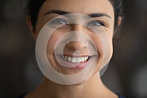 Close up head shot smiling Indian woman with perfect skin