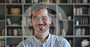 Close up head shot young happy handsome man in glasses looking at camera.