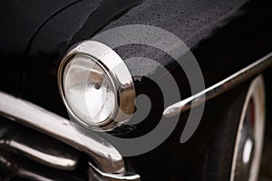 Close-up of Headlight on Black 1950 Plymouth