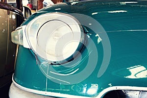 Close Up of Headlight Lamp Vintage Classic Car.