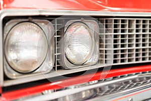Close Up of Headlight of Red Classic Car