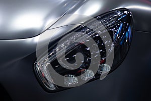 Close up headlight sport car grey color