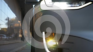 Close up of headlights of modern car. Switching of automobile LED head lights. New auto headlamp. Front of vehicle with