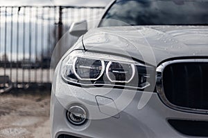 Close-up headlights of a modern white color car. Led light. Detail on the front light of a car