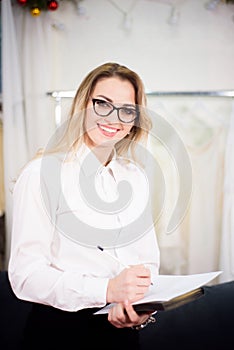 Close up headshot portrait of smiling successful caucasian woman fashion designer or tailor pose in office.
