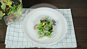 Close up of Health conscious young chief woman tossing a tasty organic green salad