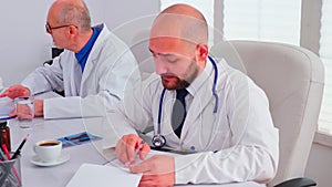 Close up of healthcare physician checking notes on clipboard