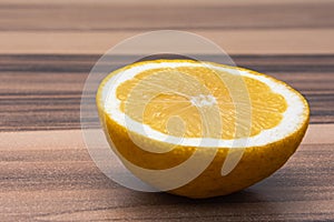 Close up of healthy citrous fruit, half of yellow lemon on a wood table photo