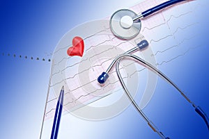 Close-up of healthy electrocardiogram results. Blue doctor`s stethoscope. The concept of maintaining a healthy heart